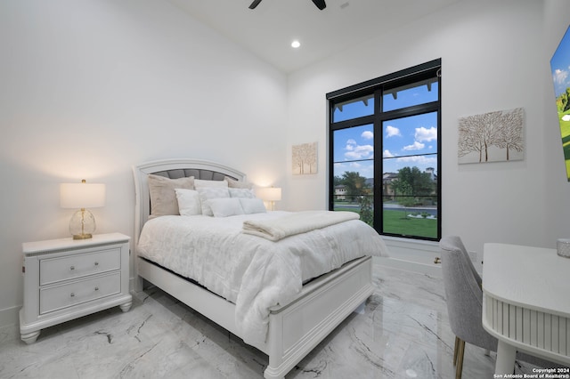 bedroom with a towering ceiling and ceiling fan