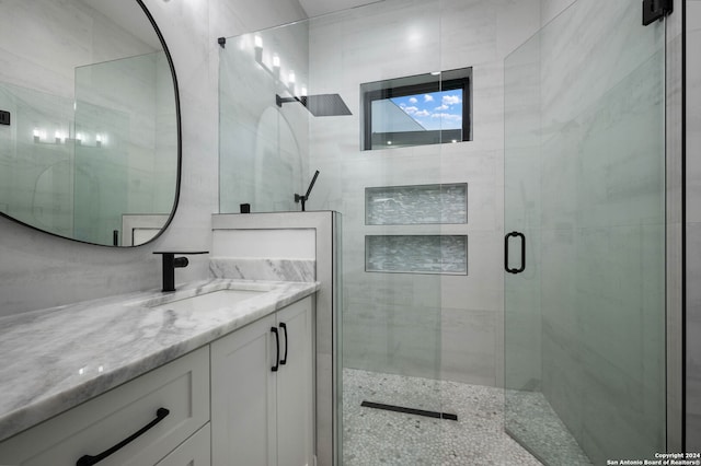 bathroom featuring walk in shower and vanity