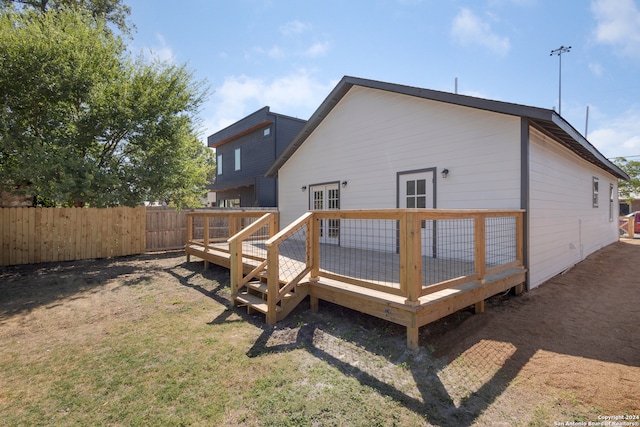 rear view of house with a yard and a deck