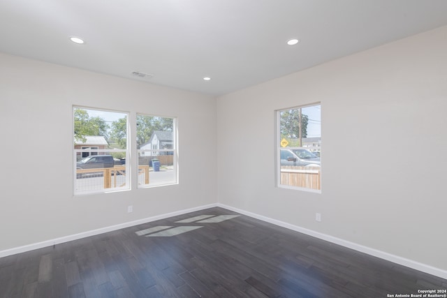 empty room with dark wood-type flooring