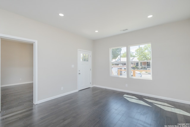 unfurnished room with dark hardwood / wood-style flooring