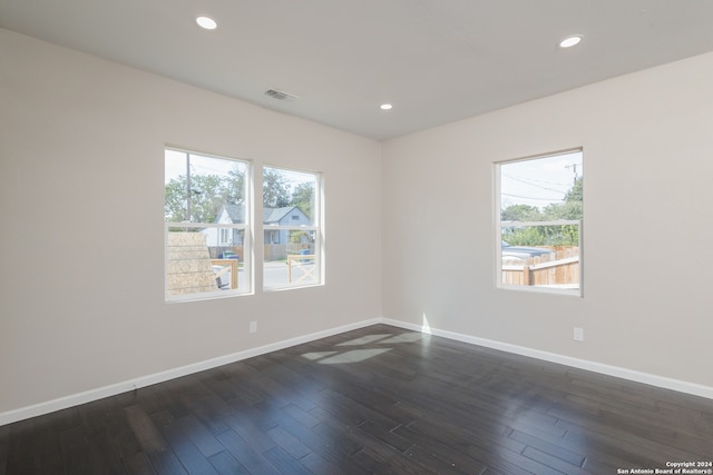 unfurnished room with dark hardwood / wood-style floors