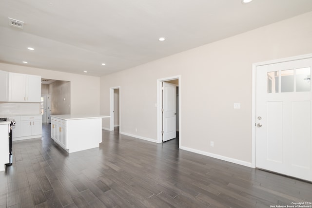 kitchen featuring white cabinets, dark hardwood / wood-style floors, white range oven, and a kitchen island