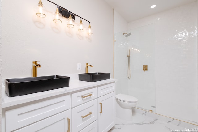 bathroom featuring vanity, tiled shower, and toilet