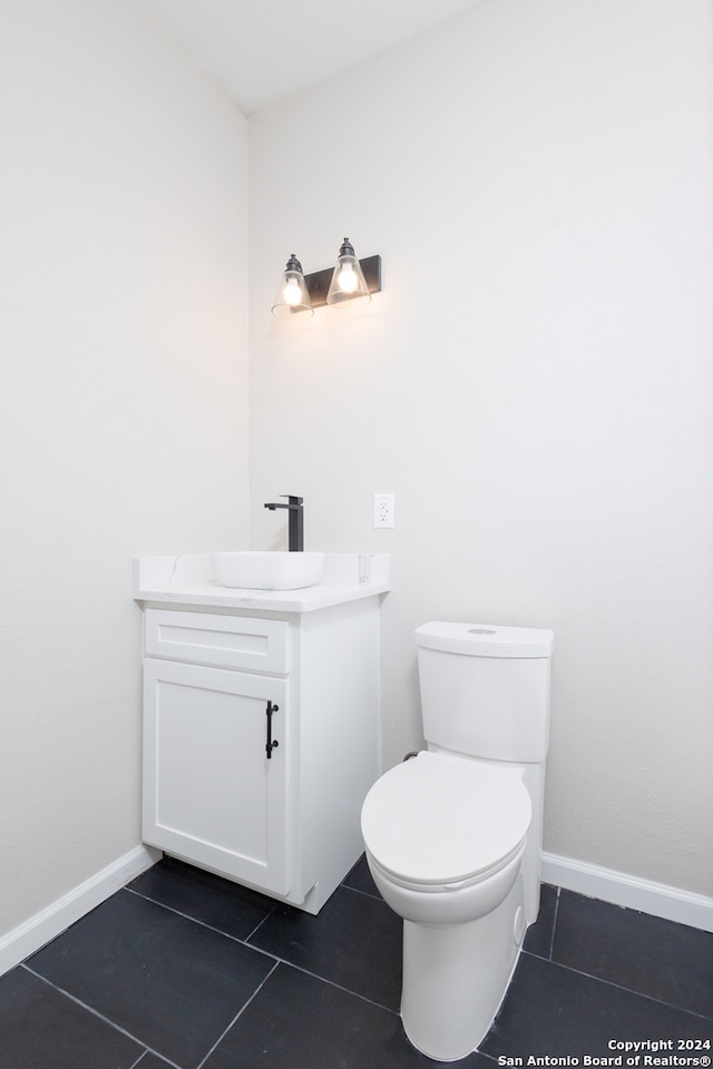 bathroom featuring tile patterned floors, toilet, and vanity