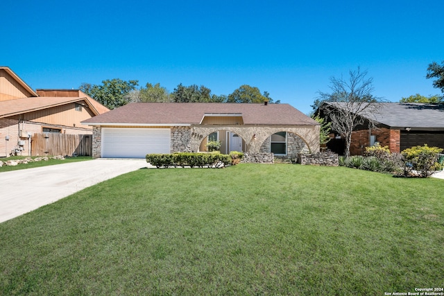 ranch-style home with a garage and a front lawn