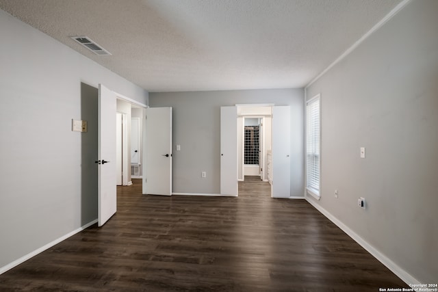 unfurnished bedroom featuring a textured ceiling and dark wood-type flooring