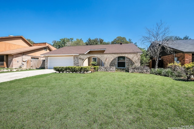 single story home with a front yard and a garage