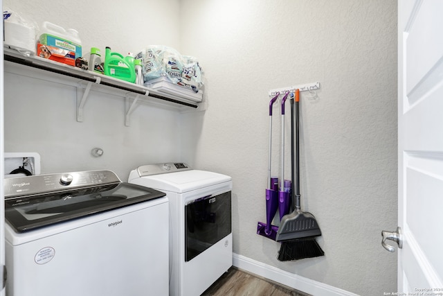 washroom with separate washer and dryer and dark wood-type flooring