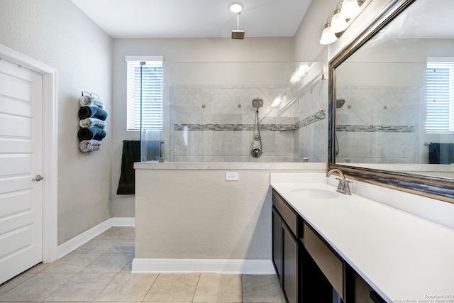 bathroom featuring vanity, a tile shower, and tile patterned floors