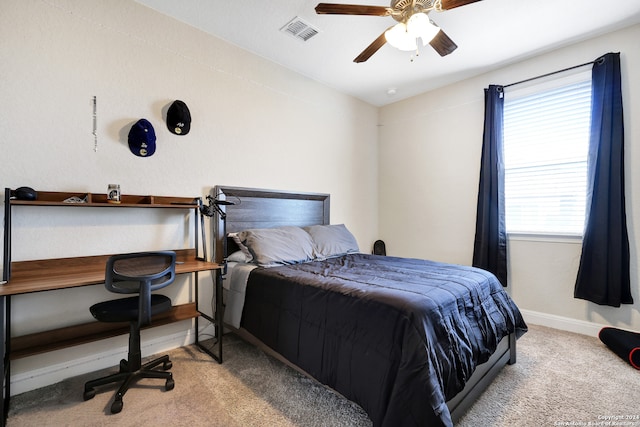 bedroom with ceiling fan, light carpet, and multiple windows