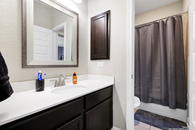 full bathroom with shower / tub combo with curtain, tile patterned flooring, vanity, and toilet