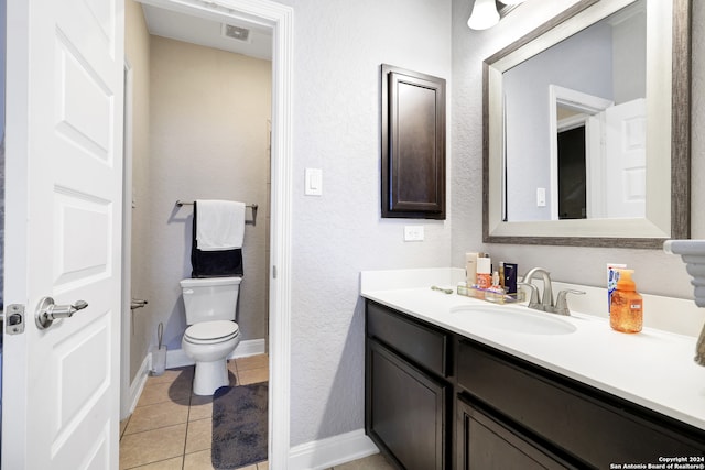 bathroom featuring tile patterned flooring, vanity, and toilet