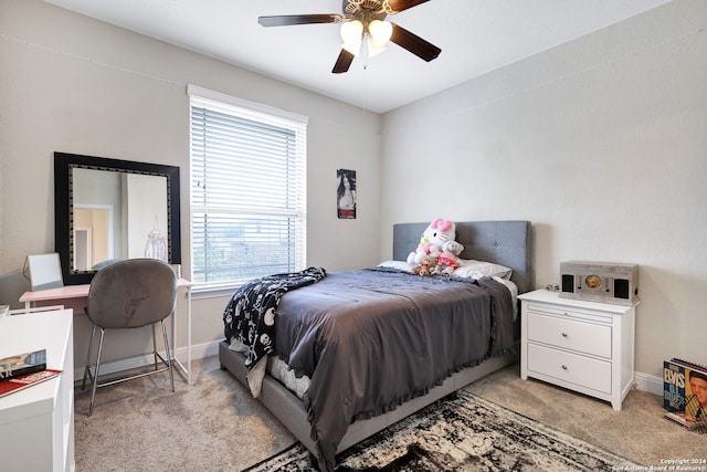 bedroom with ceiling fan, light carpet, and multiple windows