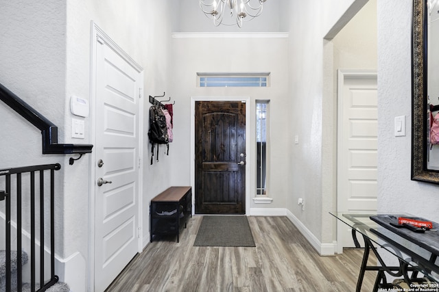 foyer entrance featuring light hardwood / wood-style floors and a chandelier