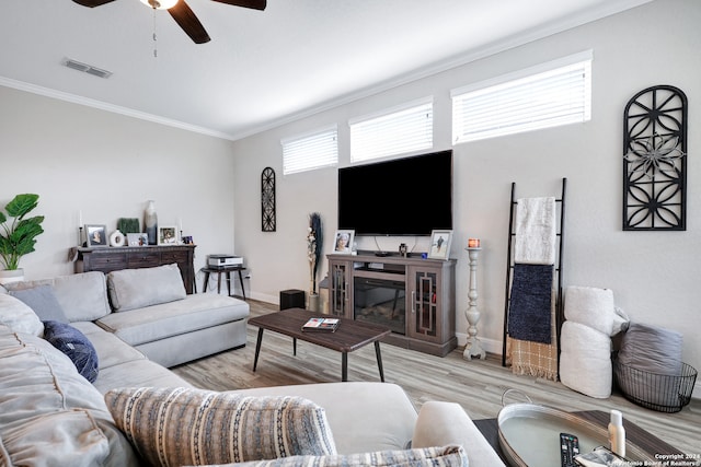 living room with ceiling fan, a fireplace, crown molding, and light hardwood / wood-style floors