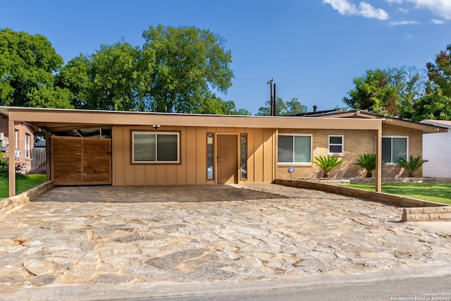 ranch-style home featuring a carport