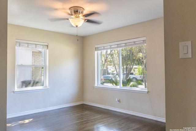 spare room with ceiling fan and dark hardwood / wood-style floors