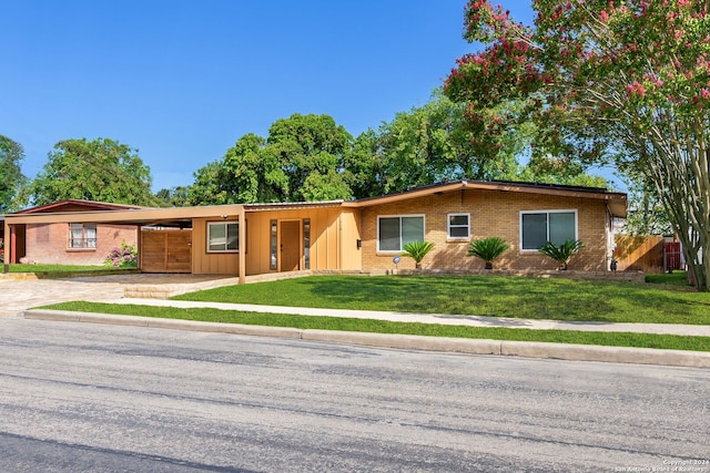 ranch-style house with a front yard and a carport