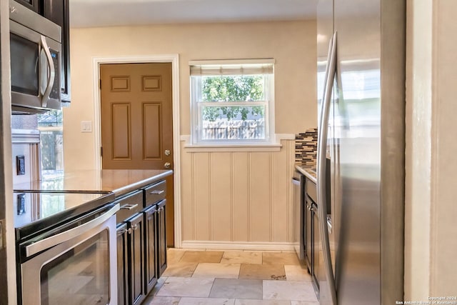 kitchen featuring dark brown cabinetry and appliances with stainless steel finishes