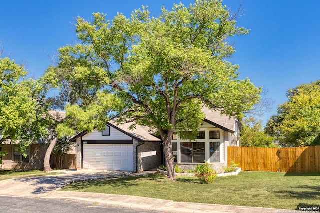 view of front of house with a front lawn and a garage