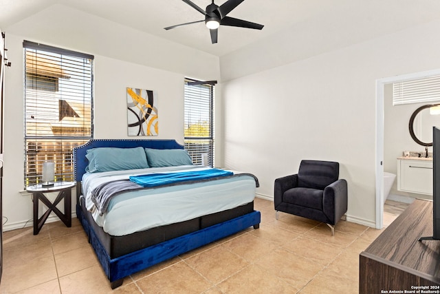 bedroom featuring ceiling fan, connected bathroom, and light tile patterned floors