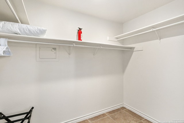 walk in closet with tile patterned floors