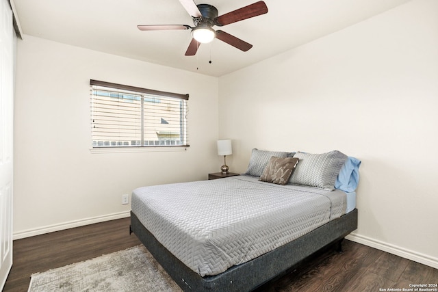 bedroom with ceiling fan and dark hardwood / wood-style flooring