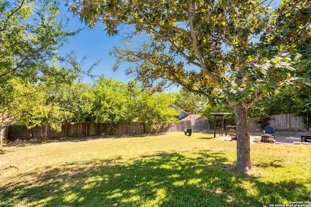 view of yard with a fire pit and a patio area