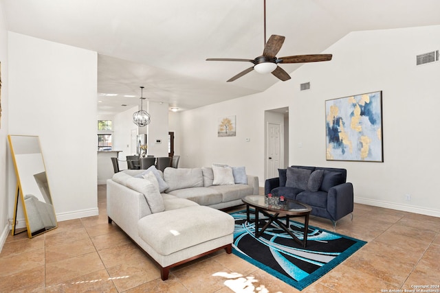 living room featuring ceiling fan with notable chandelier and lofted ceiling