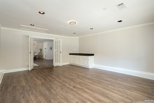 unfurnished living room featuring ornamental molding, french doors, and hardwood / wood-style flooring