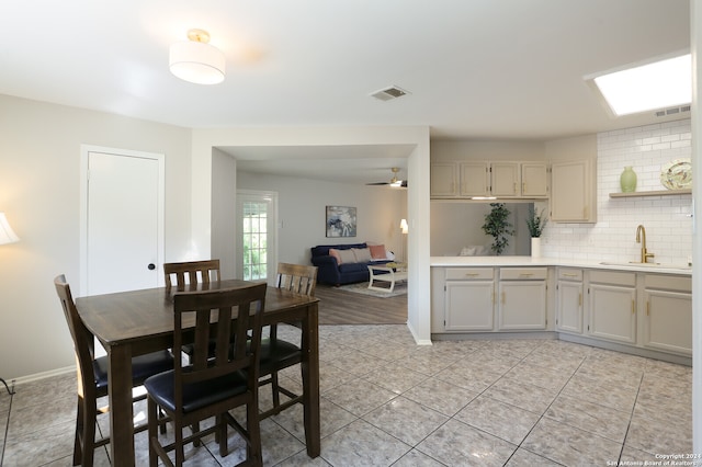 tiled dining space with sink and ceiling fan