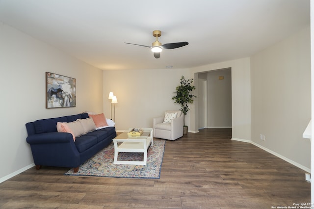 living room with dark hardwood / wood-style floors and ceiling fan