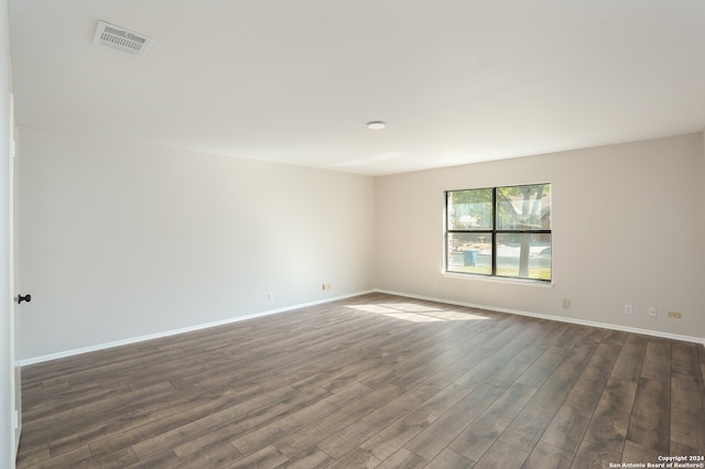 empty room with dark wood-type flooring