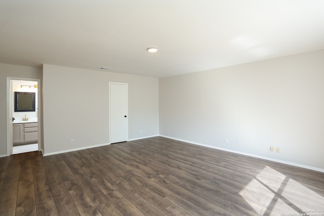 spare room with dark hardwood / wood-style floors