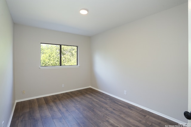 spare room with dark hardwood / wood-style flooring