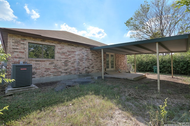 rear view of property featuring a patio and central air condition unit