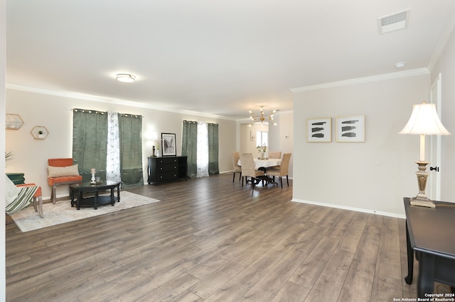 living room featuring ornamental molding, an inviting chandelier, and hardwood / wood-style floors