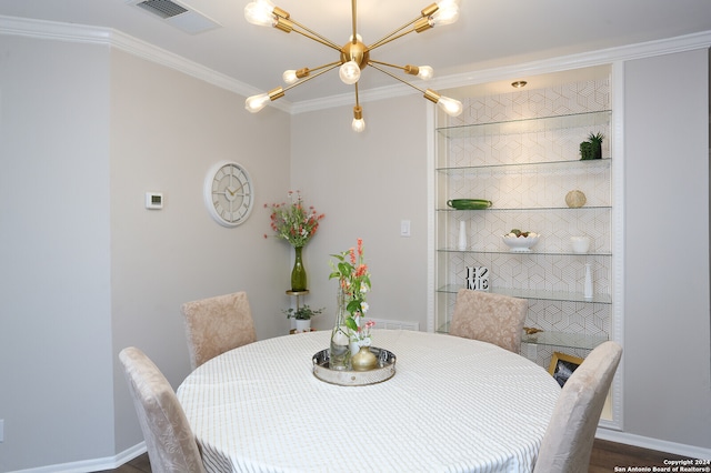 dining area featuring a chandelier, ornamental molding, and dark hardwood / wood-style flooring