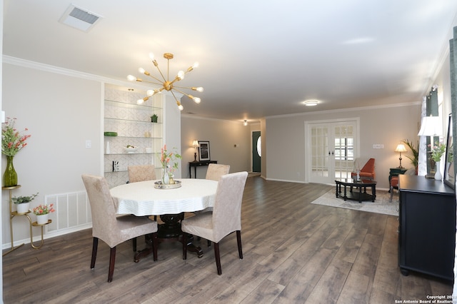 dining area with ornamental molding, a notable chandelier, and dark hardwood / wood-style floors