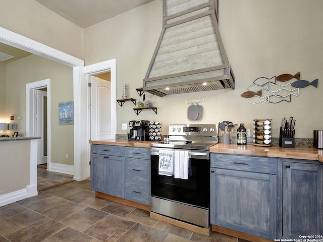 kitchen featuring gray cabinets, stainless steel electric stove, custom exhaust hood, and wooden counters