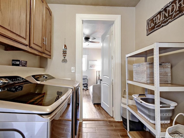 laundry room featuring cabinets, a textured ceiling, dark hardwood / wood-style flooring, ceiling fan, and washer and clothes dryer