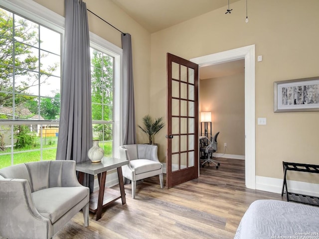 sitting room featuring light wood-type flooring and french doors