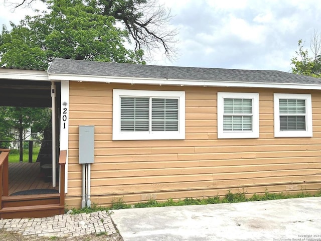 view of side of home featuring a wooden deck