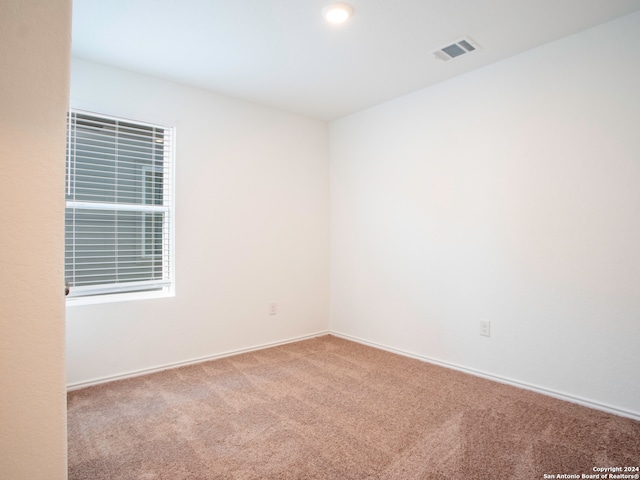 unfurnished room featuring light colored carpet