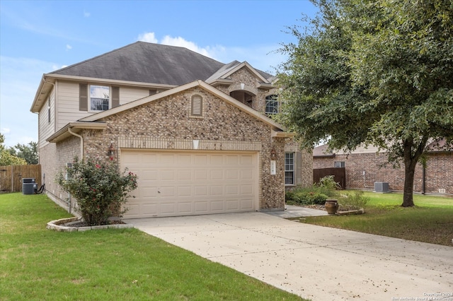 front facade featuring central AC unit, a garage, and a front lawn