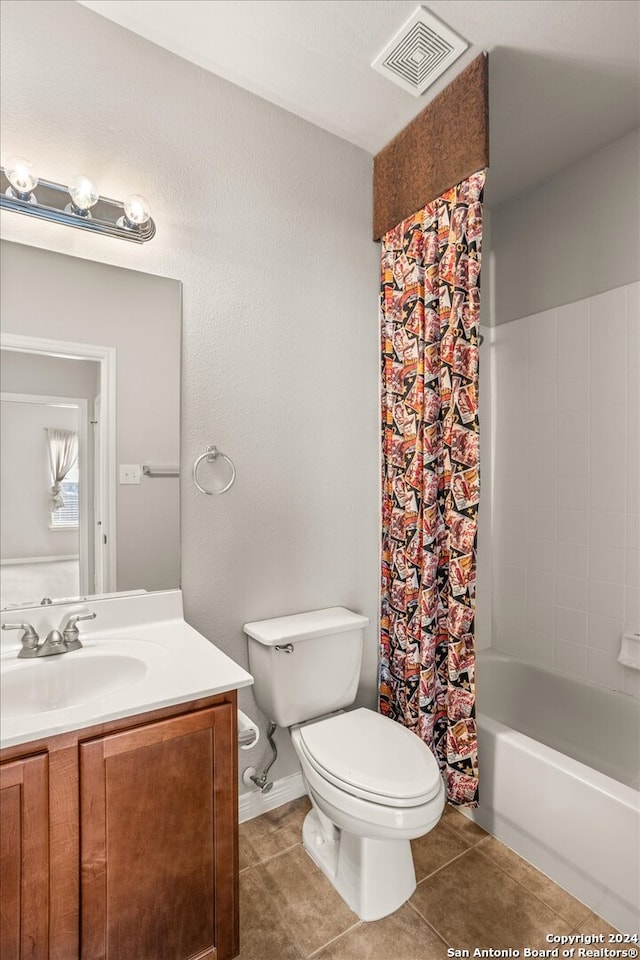 full bathroom with vanity, toilet, shower / bath combo with shower curtain, and tile patterned floors