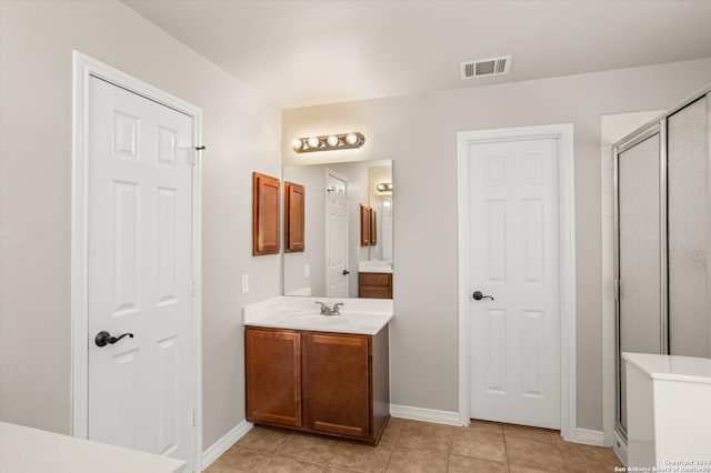 bathroom featuring vanity, an enclosed shower, and tile patterned floors