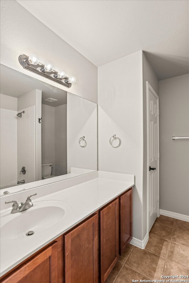 bathroom with vanity, toilet, and tile patterned floors