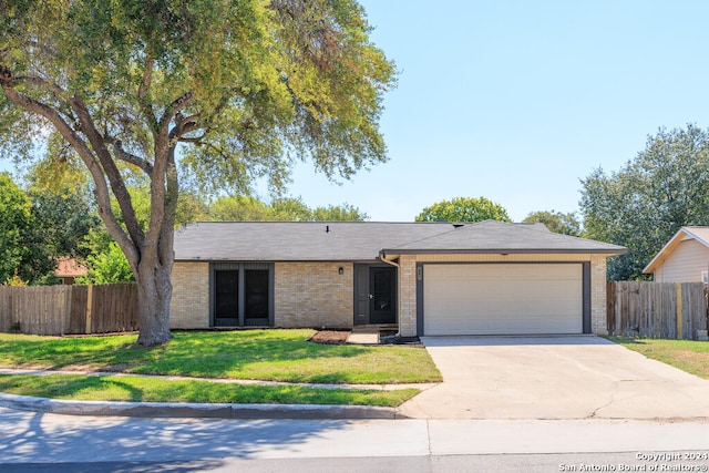 ranch-style home featuring a garage and a front yard